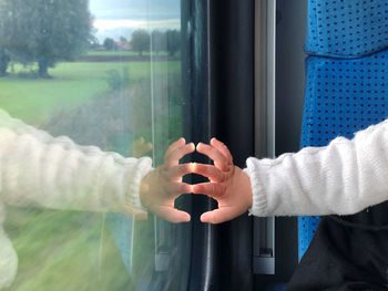Kid hand reflection in a train window