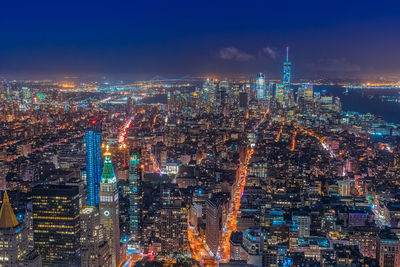 High angle view of illuminated city buildings at night