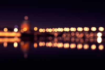 Defocused image of illuminated city at night