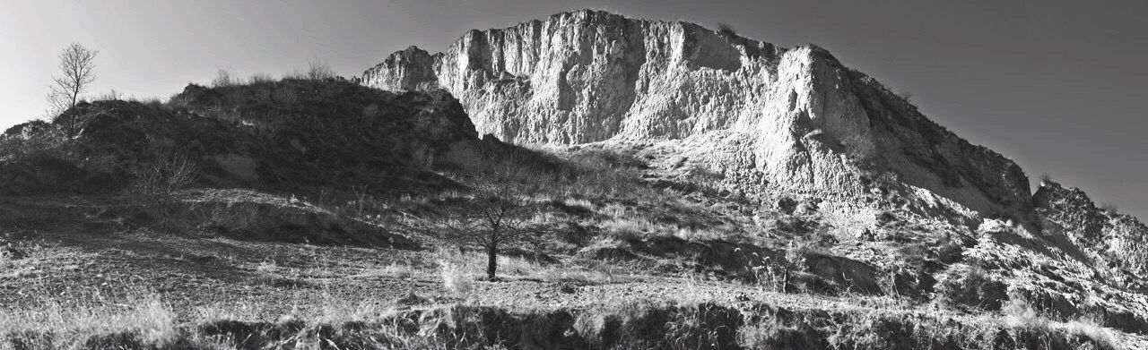 mountain, tranquil scene, tranquility, scenics, rock formation, beauty in nature, nature, rock - object, sky, cliff, geology, non-urban scene, landscape, idyllic, rocky mountains, tree, physical geography, low angle view, remote, day