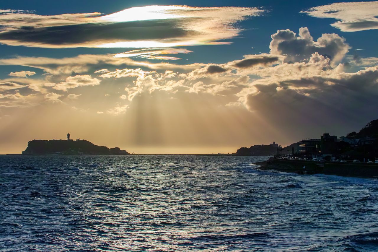 sky, cloud - sky, water, sea, beauty in nature, scenics - nature, waterfront, no people, sunbeam, nature, sunset, architecture, tranquility, outdoors, sunlight, tranquil scene, built structure, building exterior, idyllic, power in nature