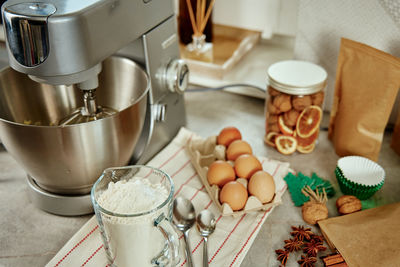 Electric mixer kneads dough in the kitchen