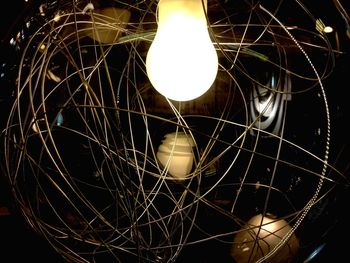 Low angle view of illuminated spider web