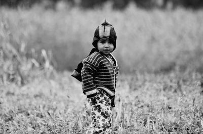 Portrait of boy standing on field