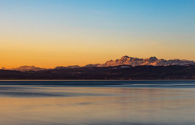 Scenic view of lake against romantic sky at sunset