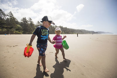 Brother and sister playing at the beach.