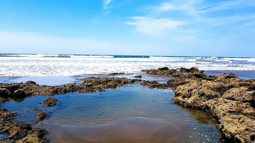 Scenic view of sea against blue sky