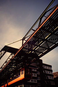 Low angle view of suspension bridge against sky