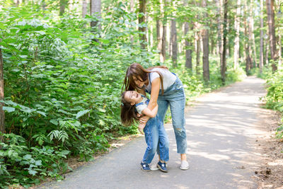 Mother and daughter on footpath