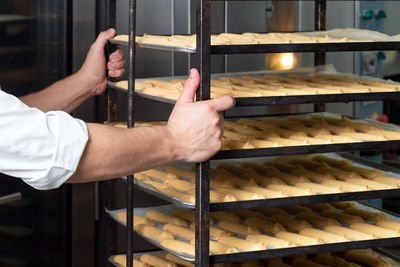 Midsection of man preparing food in store