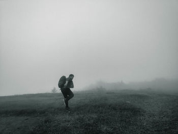 People on field during foggy weather