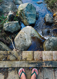 Low section of person standing on rock