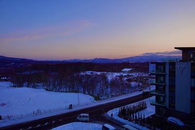 Scenic view of snowcapped mountains against sky at sunset