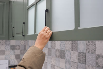 Cropped hand of man using mobile phone