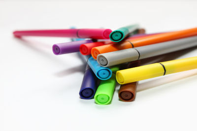 Close-up of colored pencils against white background