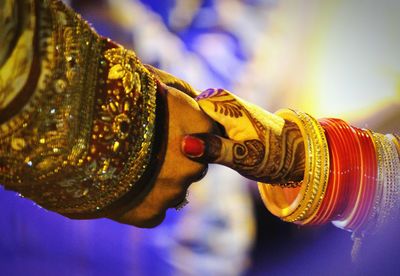 Close-up of bride and groom holding hands