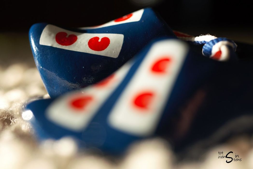 selective focus, no people, still life, close-up, arts culture and entertainment, indoors, gambling, luck, white color, multi colored, table, patriotism, leisure activity, flag, leisure games, number, group of objects, day, shape