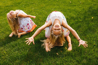 Full length of mother and daughter on grass