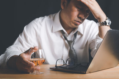 Businessman hold whiskey glass and feel stressed,