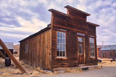 Low angle view of old building on field against sky