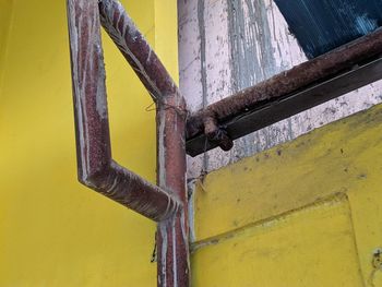 Low angle view of rusty metal on wall