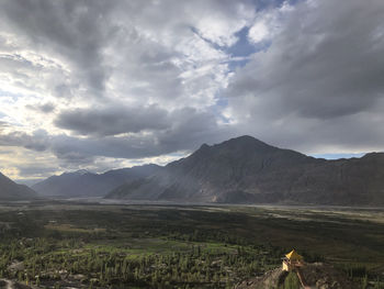 Scenic view of landscape and mountains against sky