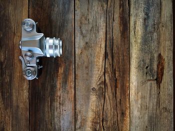 Directly above shot of vintage camera on wooden table