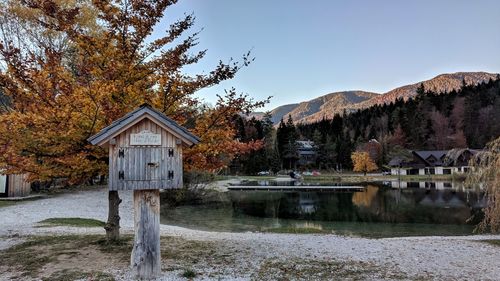 Built structure by lake against sky