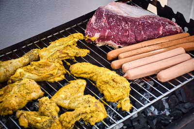 High angle view of meat on barbecue grill