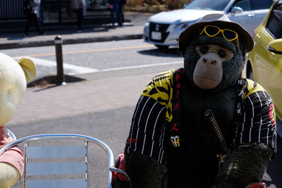 Gorilla toy on chair in city