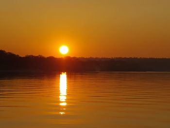 Scenic view of lake against romantic sky at sunset