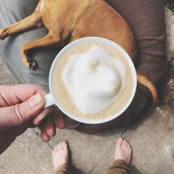 Low section of woman holding coffee cup