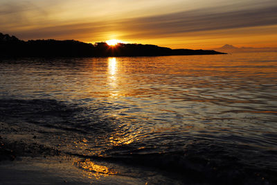 Scenic view of oceanagainst romantic sky at sunrise 