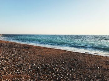 Scenic view of beach against clear sky