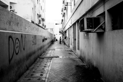 Alley amidst buildings in city