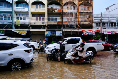 View of vehicles on road along buildings