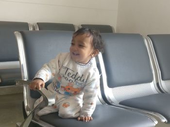 Cute girl sitting on seat in bus