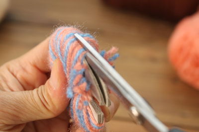 Cropped hand cutting wool using scissors