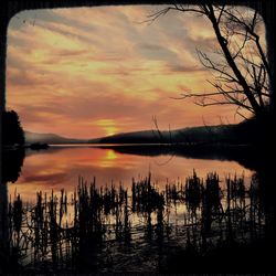 Scenic view of lake against romantic sky at sunset