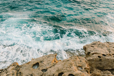 View of waves breaking on rocks