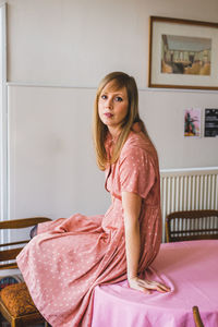 Portrait of woman sitting at home