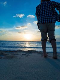 Rear view of a man walking on beach