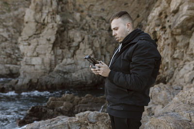 Young man standing on rock