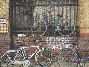Bicycle parked against brick wall