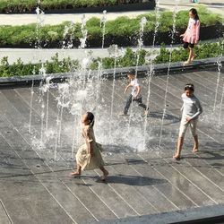 Siblings playing in water