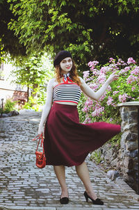 Portrait. young, happy, elegant redhead curly woman, girl in hat, casual clothes. french style. city