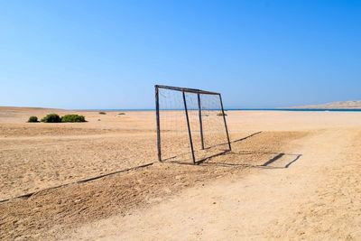 Scenic view of desert against clear blue sky