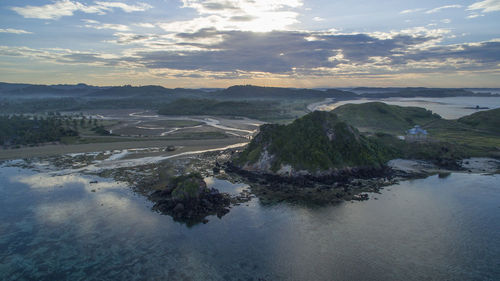 Scenic view of river against sky at sunset