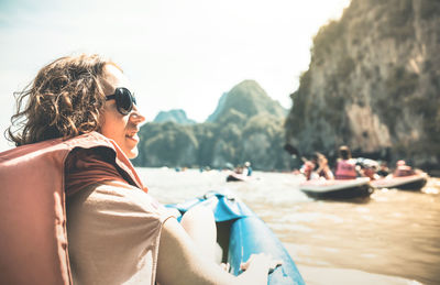 Woman in sunglasses sitting at beach