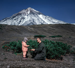 People on snow covered mountain against sky